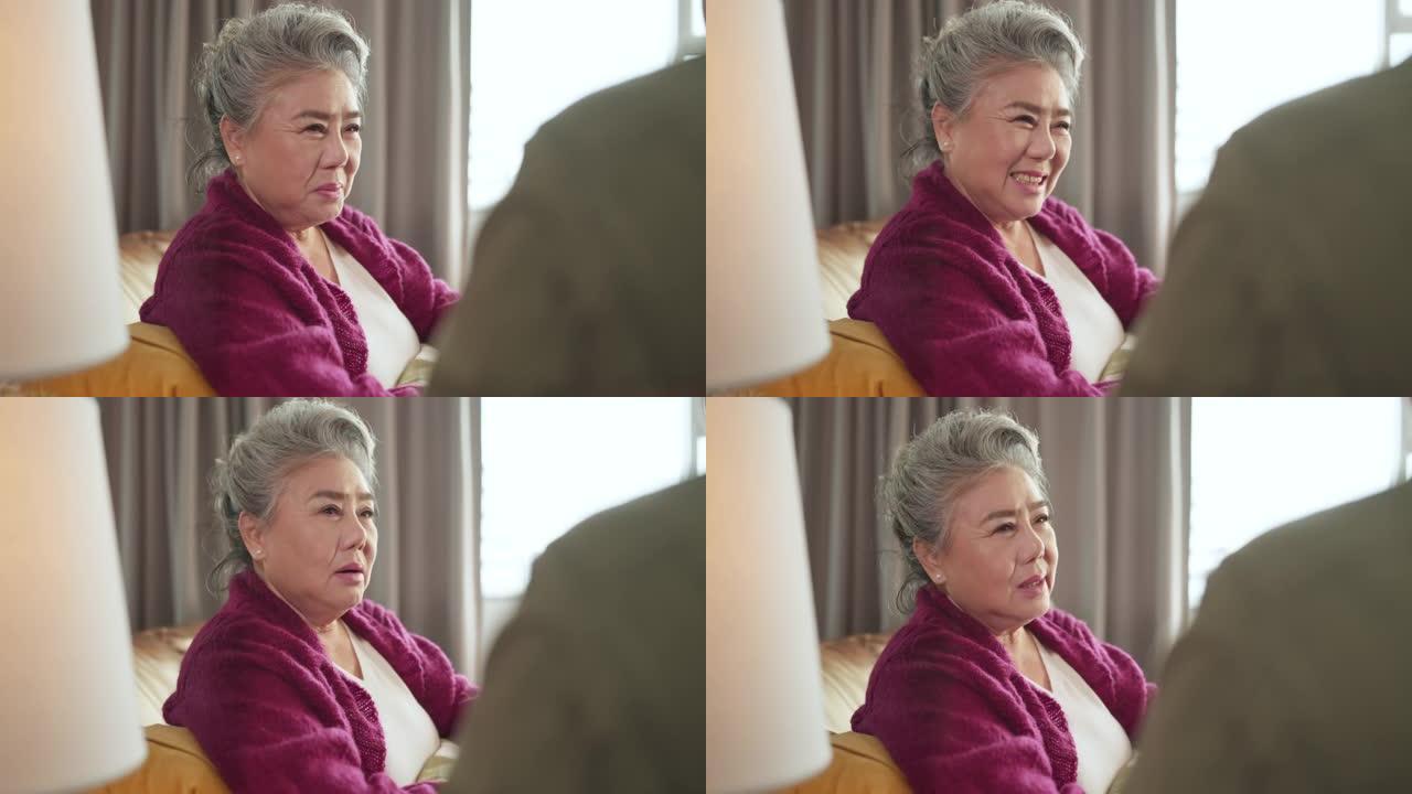 幸福亚洲成人退休女性休闲布放松坐着谈话与家庭假日周末在沙发沙发客厅，亚洲老年女性与家庭关系良好呆在家