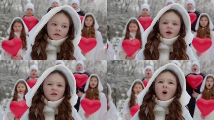 一群孩子在白雪皑皑的公园里唱一首歌