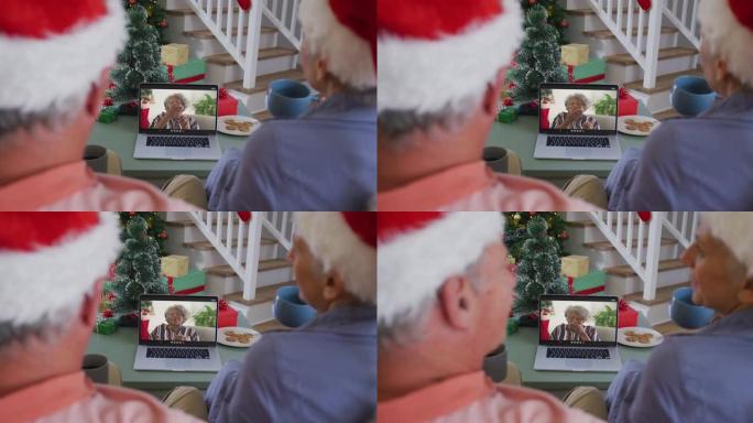 快乐的高级高加索夫妇在圣诞节与高级女性朋友在笔记本电脑上进行视频通话