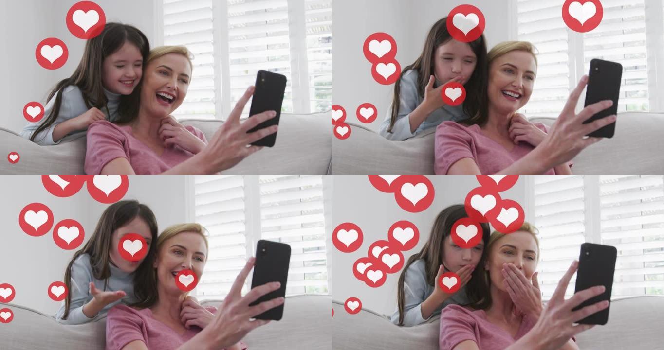 高加索金发母女在家智能手机上聊天的心脏图标动画