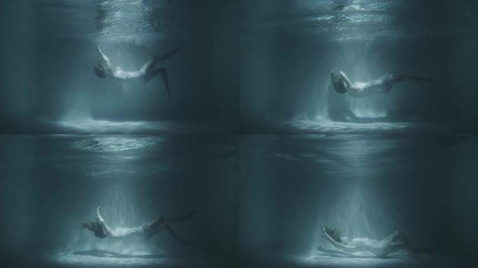 一个穿着白色连衣裙的女孩落在水下