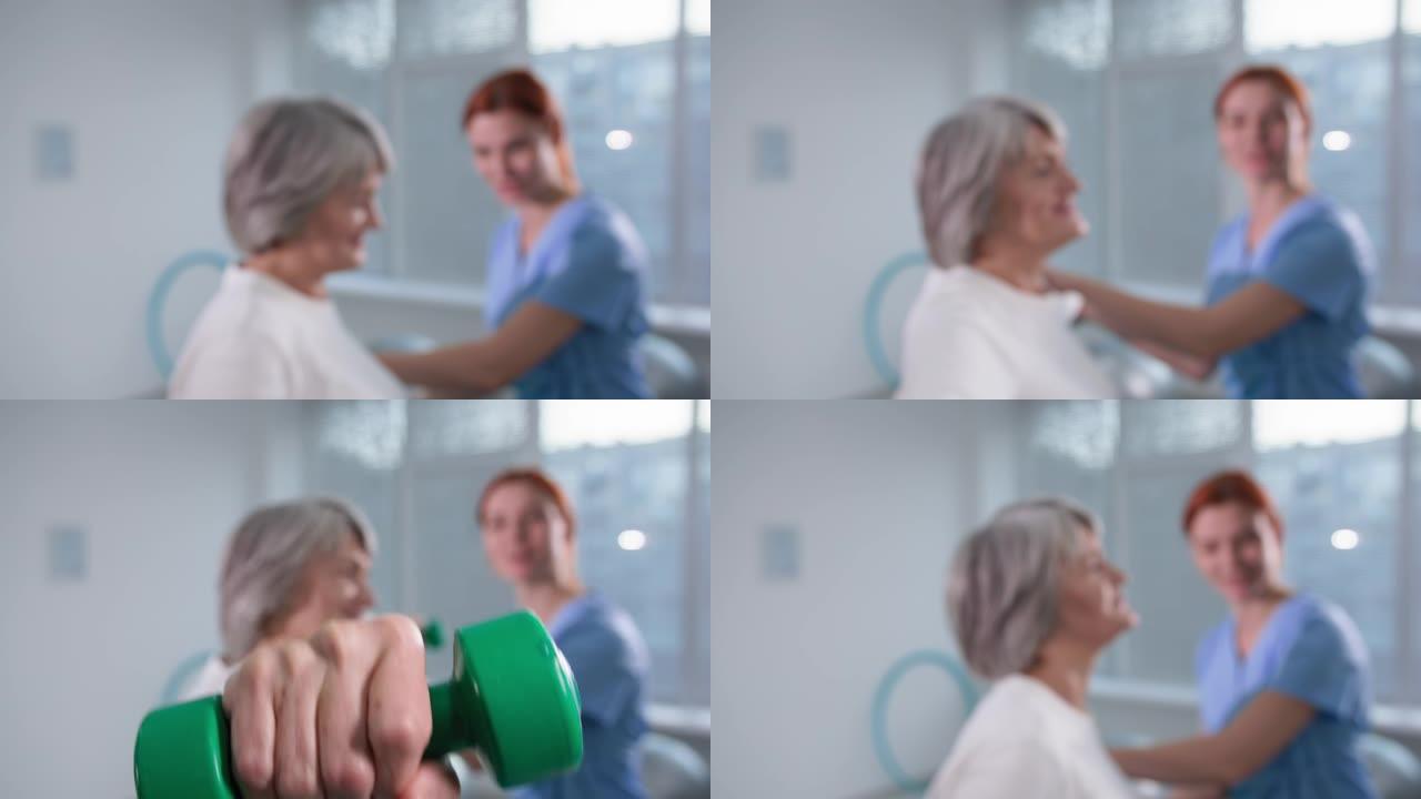 康复治疗，女理疗师用哑铃帮助老病人锻炼手臂，保健和护理服务