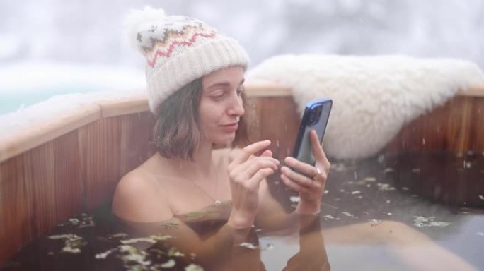 女人在雪山的热水浴中放松