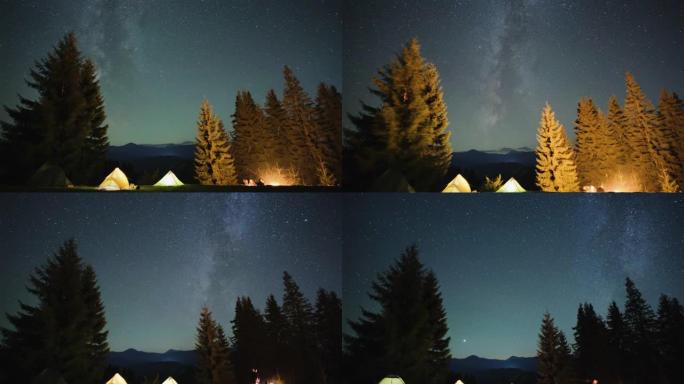 徒步旅行者在夜空下闪闪发光的星星的夜空中，除了在照明的旅游帐篷附近燃烧篝火旁休息。积极的生活方式和户