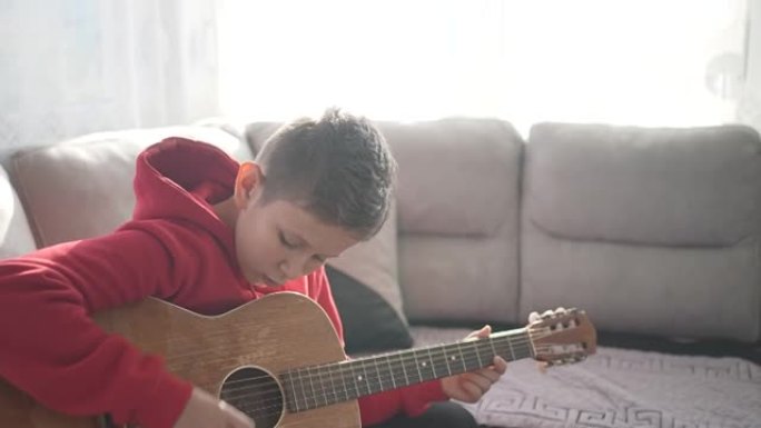 小男孩学习如何弹吉他