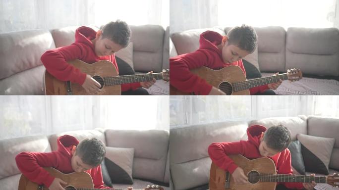 小男孩学习如何弹吉他