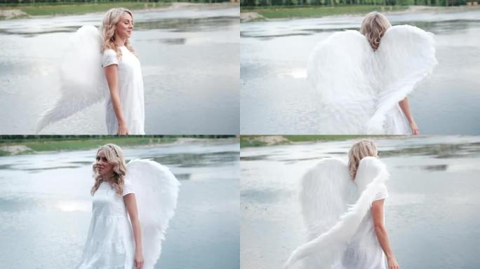 穿着白色连衣裙的美丽天使。惊人的金发女人，长长的卷发和白色的翅膀。慢动作