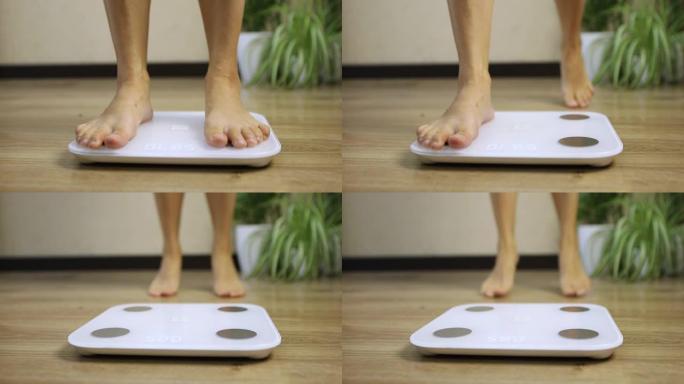 女性踩在体重秤上控制体重