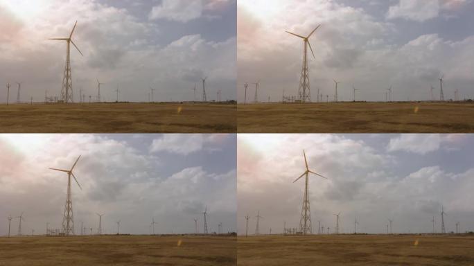 风车在晴天的剪影中产生能量