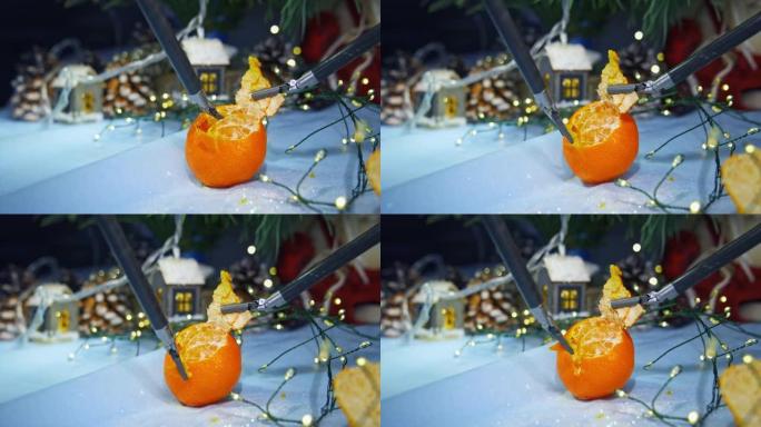 医疗机器人手术剥去水果。机器人手臂的小爪子从橘子上剥下。背景上的圣诞装饰品。