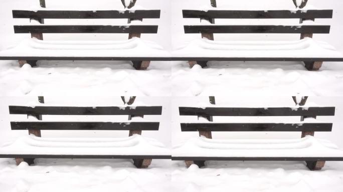 在雪堆中慢动作覆盖着雪的长凳