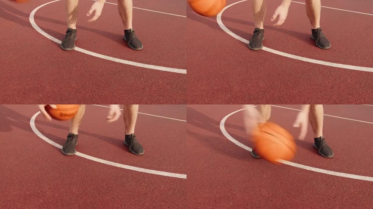 夏天，一个男人的腿通过在室外球场上两腿之间滚动篮球来练习球技