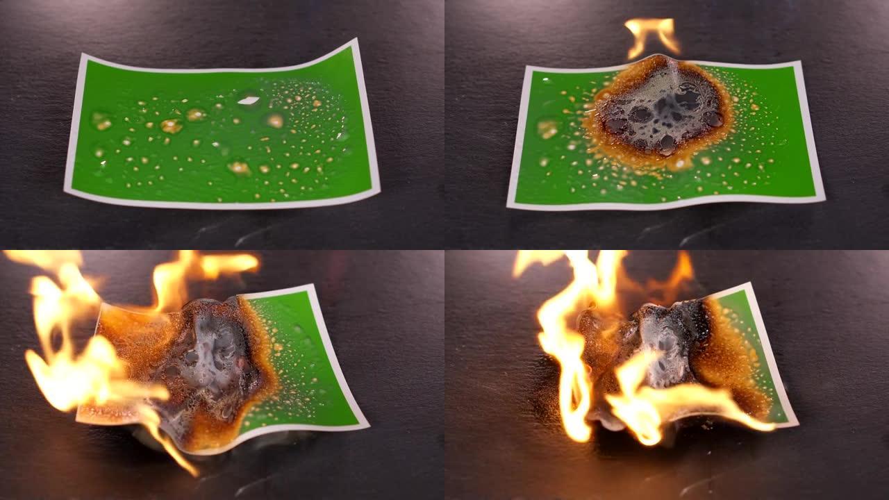 用燃气燃烧器在黑色背景上燃烧绿色照片。旧蓝牌烧坏了。图片的背景会从气体和火的高温中融化塑料