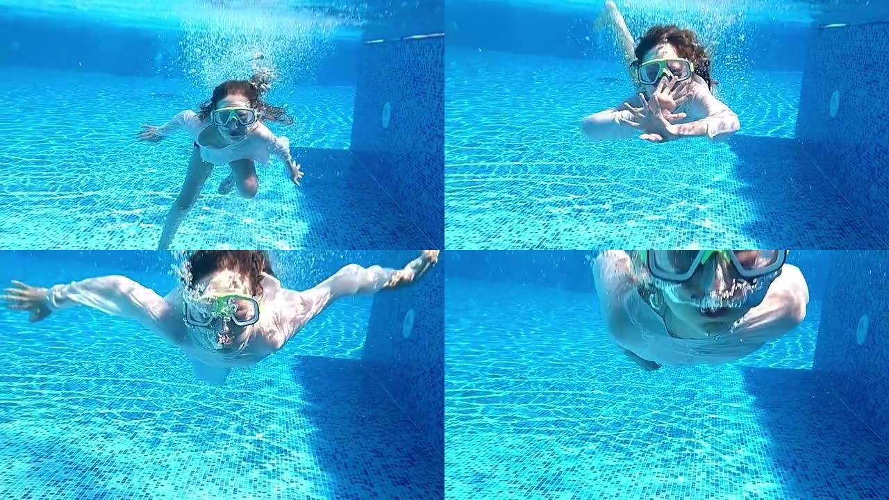 女孩戴着面具在游泳池水下游泳。