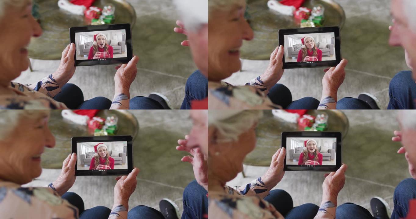 高级高加索夫妇使用平板电脑与屏幕上的幸福女人进行圣诞节视频通话