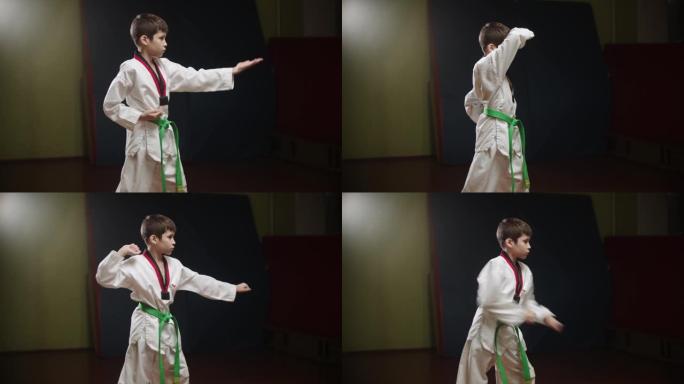 一个做跆拳道的小男孩-站着姿势并用手臂展示动作
