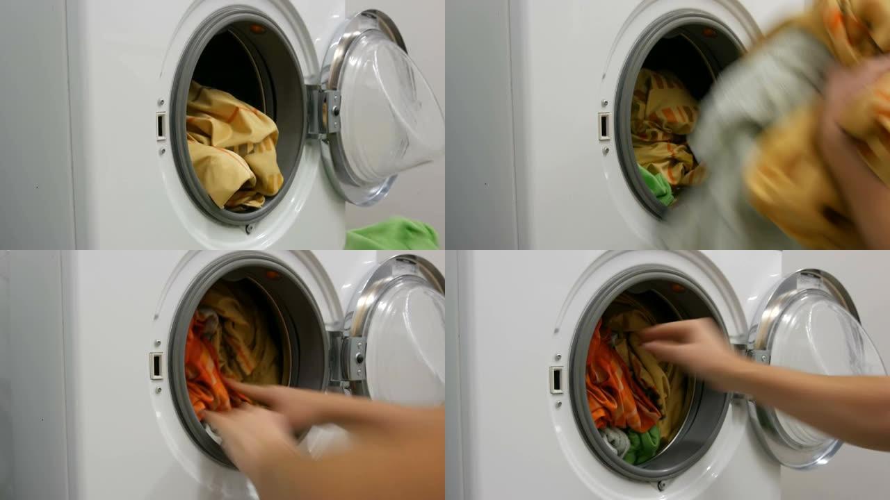 男性的手将洗过的彩色衣物装入洗衣机，然后放入装有洗衣粉的胶囊。加速射击