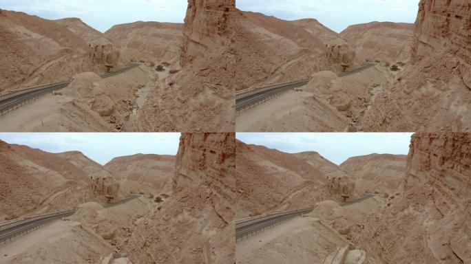 在穿越沙漠中的沙山的道路上向后滑动
