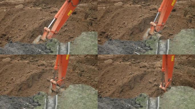 挖掘机铲斗挖掘地面。