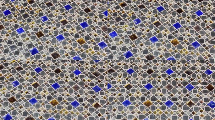 抽象视频美丽的多色马赛克作为地板覆盖物，光在光泽涂层上的反射，蓝色，白色和琥珀色的元素