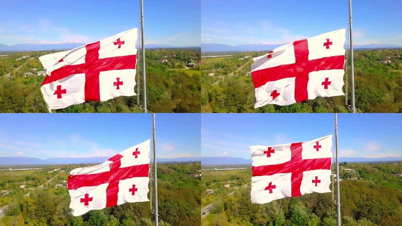 格鲁吉亚国旗飘扬在背景雪山公路村。
