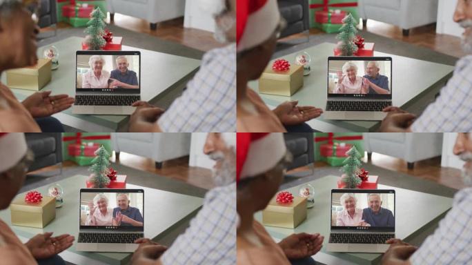 圣诞节时，与资深朋友在笔记本电脑上视频通话的快乐非裔美国夫妇