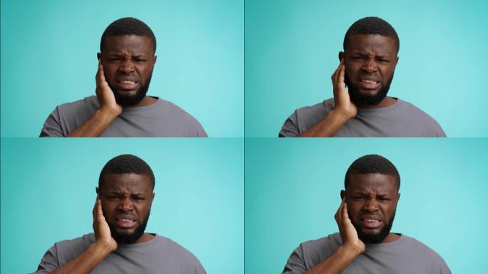 耳朵疼痛。不幸的黑人患有耳痛，触摸疼痛区域和皱眉