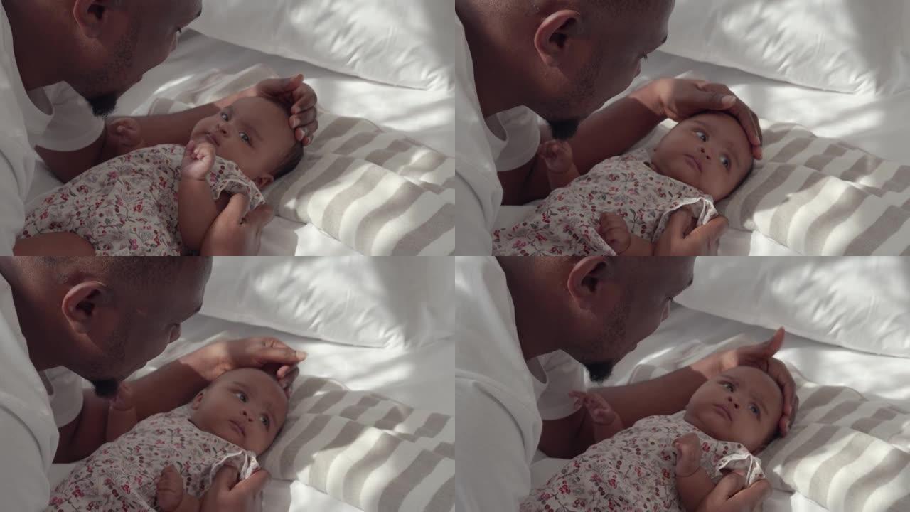 非裔美国人家庭爸爸用手抚摸婴儿为爱的女儿