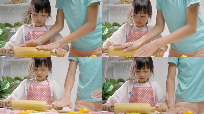亚洲女孩在成型饼干前滚动面团，庆祝圣诞节，生活方式理念。