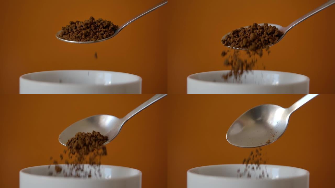 速溶咖啡块从杯子里慢动作落下。新鲜的早晨热巧克力特写。慢动作。从勺子上掉下来的咖啡粉。特写早晨可可。