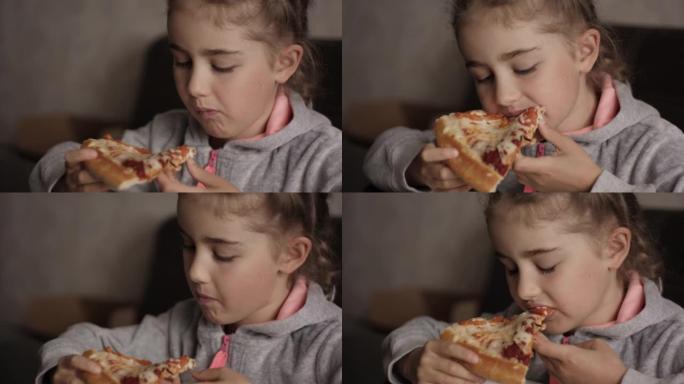 孩子吃披萨。饥饿的小女孩坐在厨房的餐桌上，从盘子里吃美味的意大利披萨。不健康的营养快餐。孩子吃午饭的