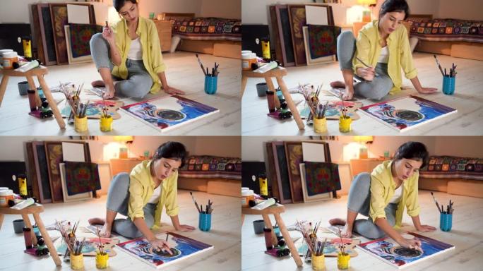 有创意的女艺术家，享受着自己爱好的每一分钟，在家中的画布油画
