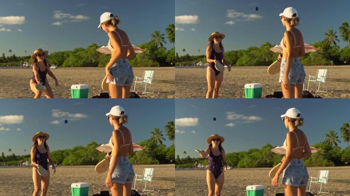 在海滩上玩划桨球的女人