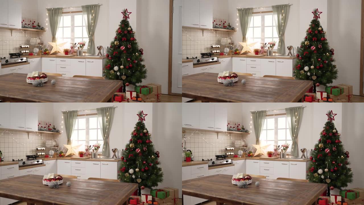 圣诞房间内部。舒适的烹饪场所由圣诞树装饰，明亮的窗户在餐桌上摆放着五颜六色的礼物。美丽的公寓为新年假