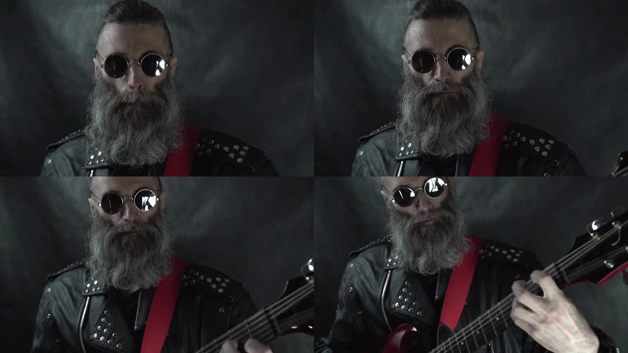 留着胡须的摇滚音乐家头部特写，剃光的太阳穴戴着圆形眼镜和皮夹克