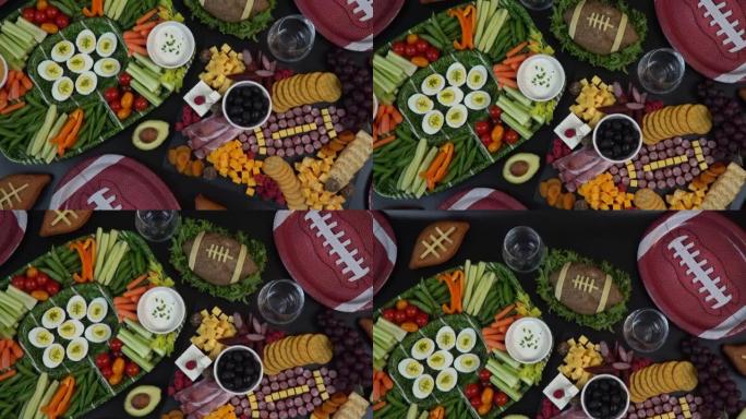 美式橄榄球比赛派对的熟食店上的香肠和奶酪制成的足球球。