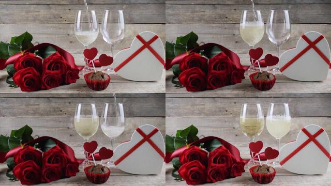 情人节。两杯香槟，红玫瑰，木制背景上的心形盒子。香槟倒了。情人节。文本的位置