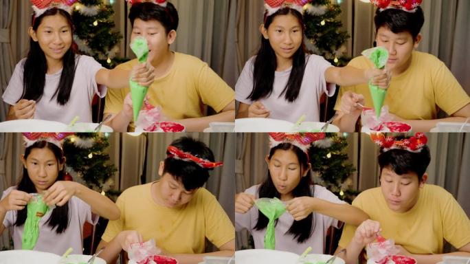 亚洲儿童准备皇家糖衣管道袋，用于装饰圣诞饼干，节日庆祝生活方式概念。