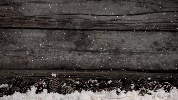 圣诞节雪落在木板和松果上的动画