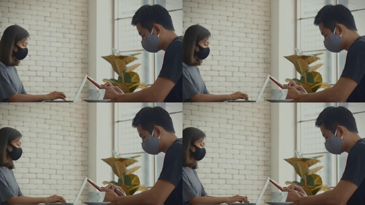 新型冠状病毒肺炎效果，在家工作，忙碌的亚洲年轻夫妇使用笔记本电脑和智能手机。家庭生活，影响新型冠状病