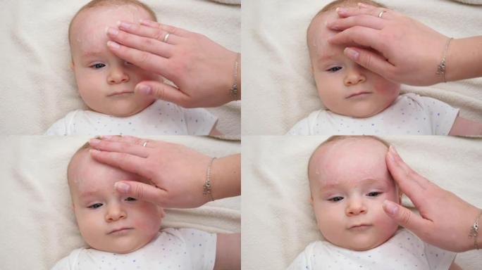 母亲涂霜保湿和清洁婴儿面部的特写镜头。新生婴儿卫生、健康和皮肤护理的概念