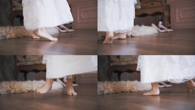 可爱的小女孩。孩子们跳舞。特写。小公主，穿着雪白的蕾丝连衣裙，跳舞，旋转，赤脚在房间里