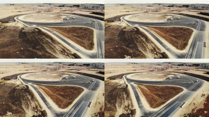 汽车试验场道路施工完成鸟瞰图。黑色沥青，带有清晰明亮的白色和黄色不同形状的道路标记。道路建设、试验场