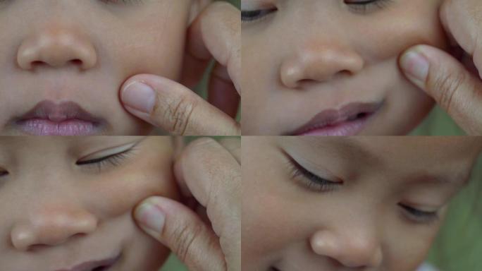 亚洲母子女孩玩捏脸颊，摸鼻子滑稽的脸。