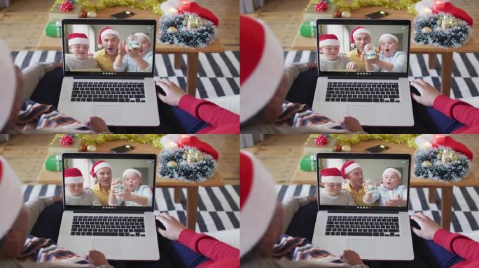 非裔美国母亲和女儿使用笔记本电脑与家人在屏幕上进行圣诞节视频通话