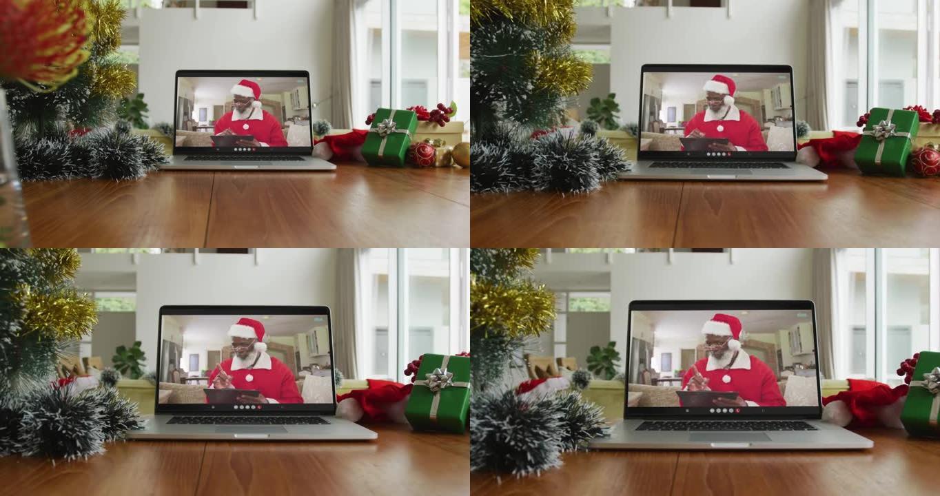 圣诞老人穿着圣诞老人服装的非裔美国人在笔记本电脑上的视频通话