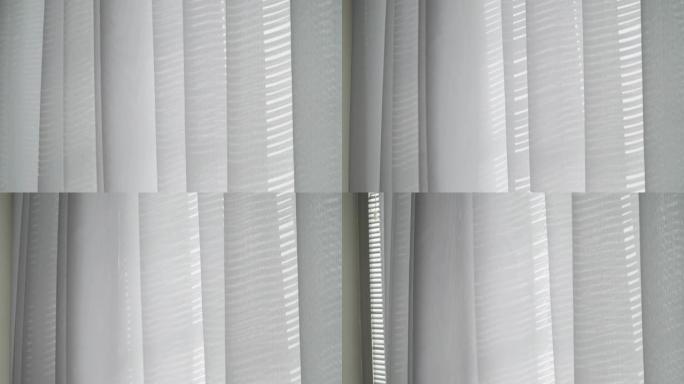 白色卧室里有窗户的白色挥舞窗帘