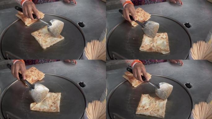 制作传统的印度食品，称为 “roti canai”，慢动作