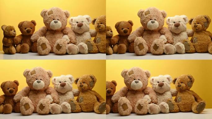 一群可爱的棕色泰迪熊坐在黄色背景上