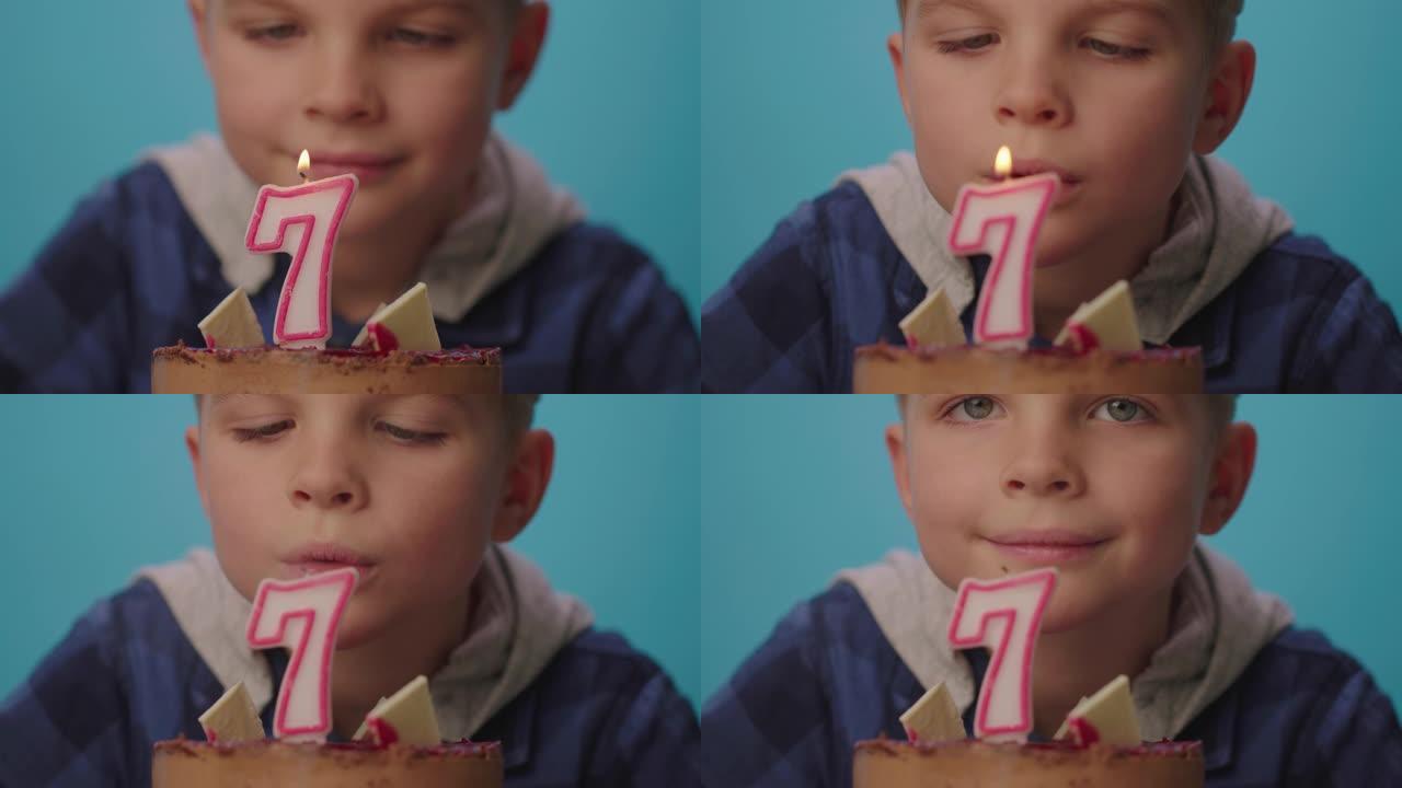 男孩的特写许愿，以慢动作吹灭7号蜡烛。七岁男孩庆祝生日。快乐的7岁孩子。